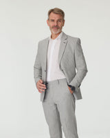 Man wearing a gray suit with a white shirt on a light gray background