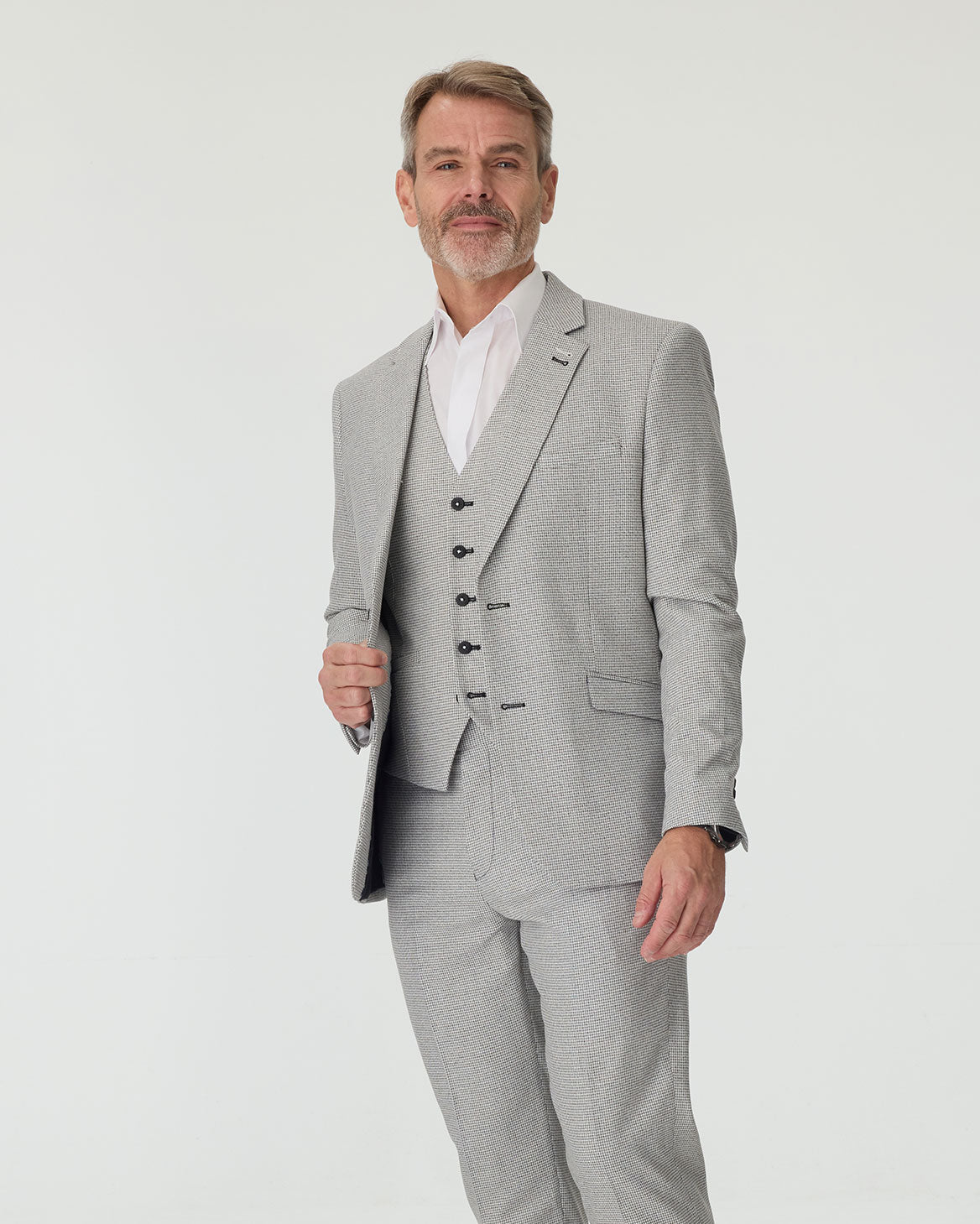 Man wearing a gray suit with a white shirt on a light gray background