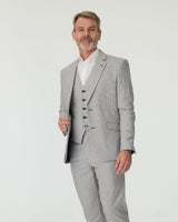 Man wearing a gray suit with a white shirt on a light gray background