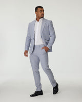 Man wearing a sky blue suit with a white shirt on a white background